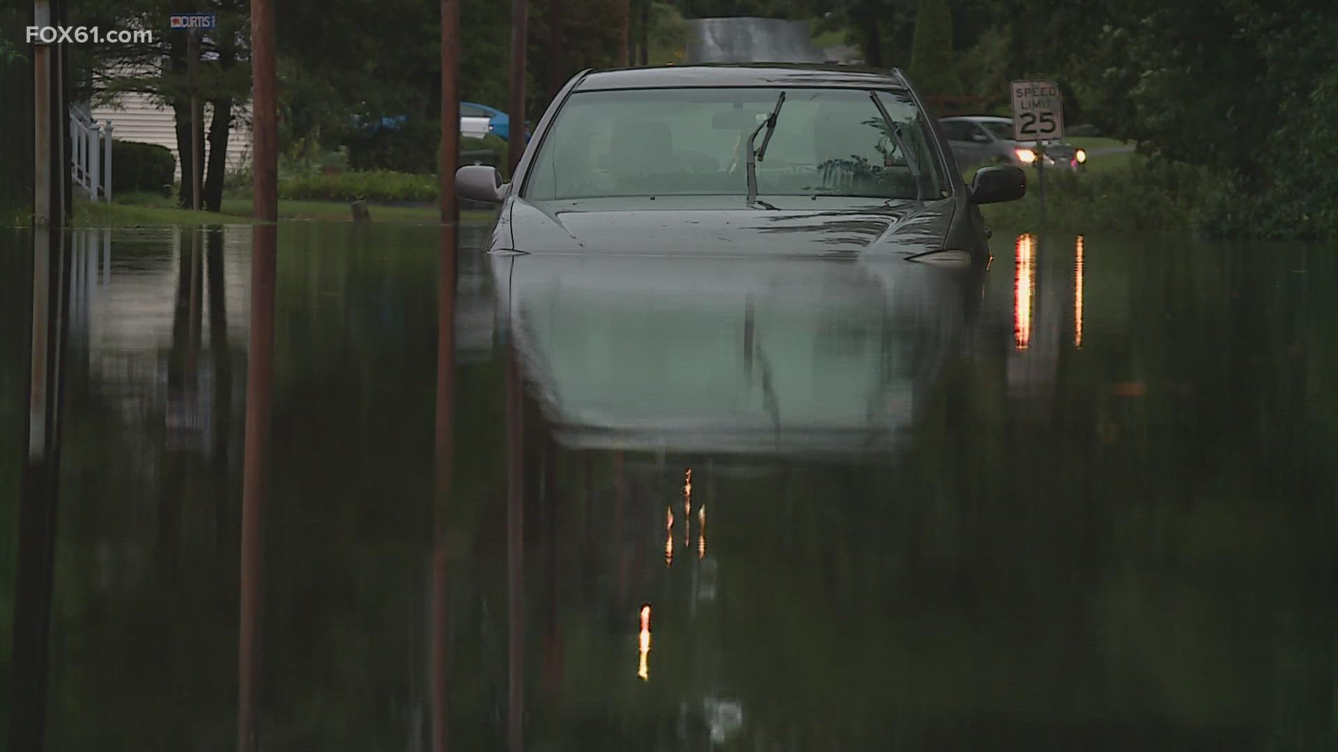 Residents at an apartment complex in Norwich work up to several inches of rainwater on the roads.