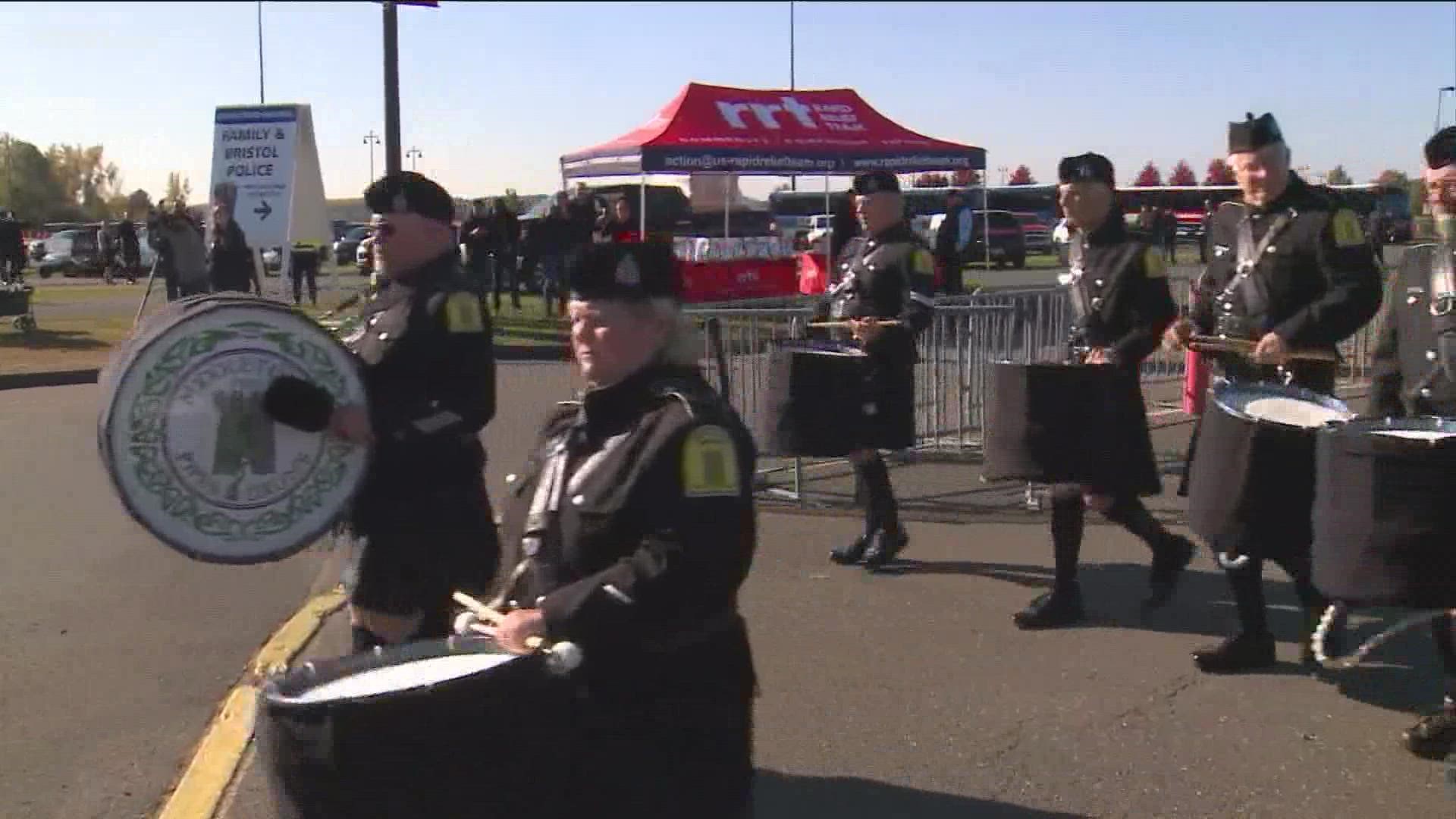 Pipe and drum corp pay respects ahead of fallen officers' funeral