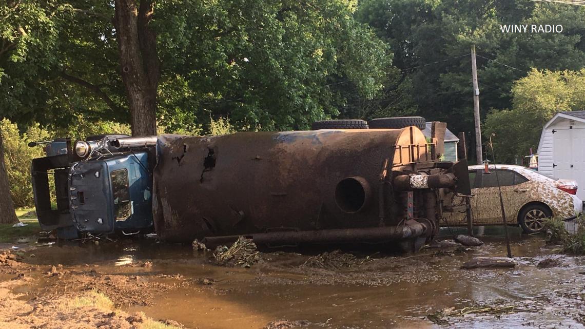 Liquid manure truck rollover crash damages car, yard in Pomfret