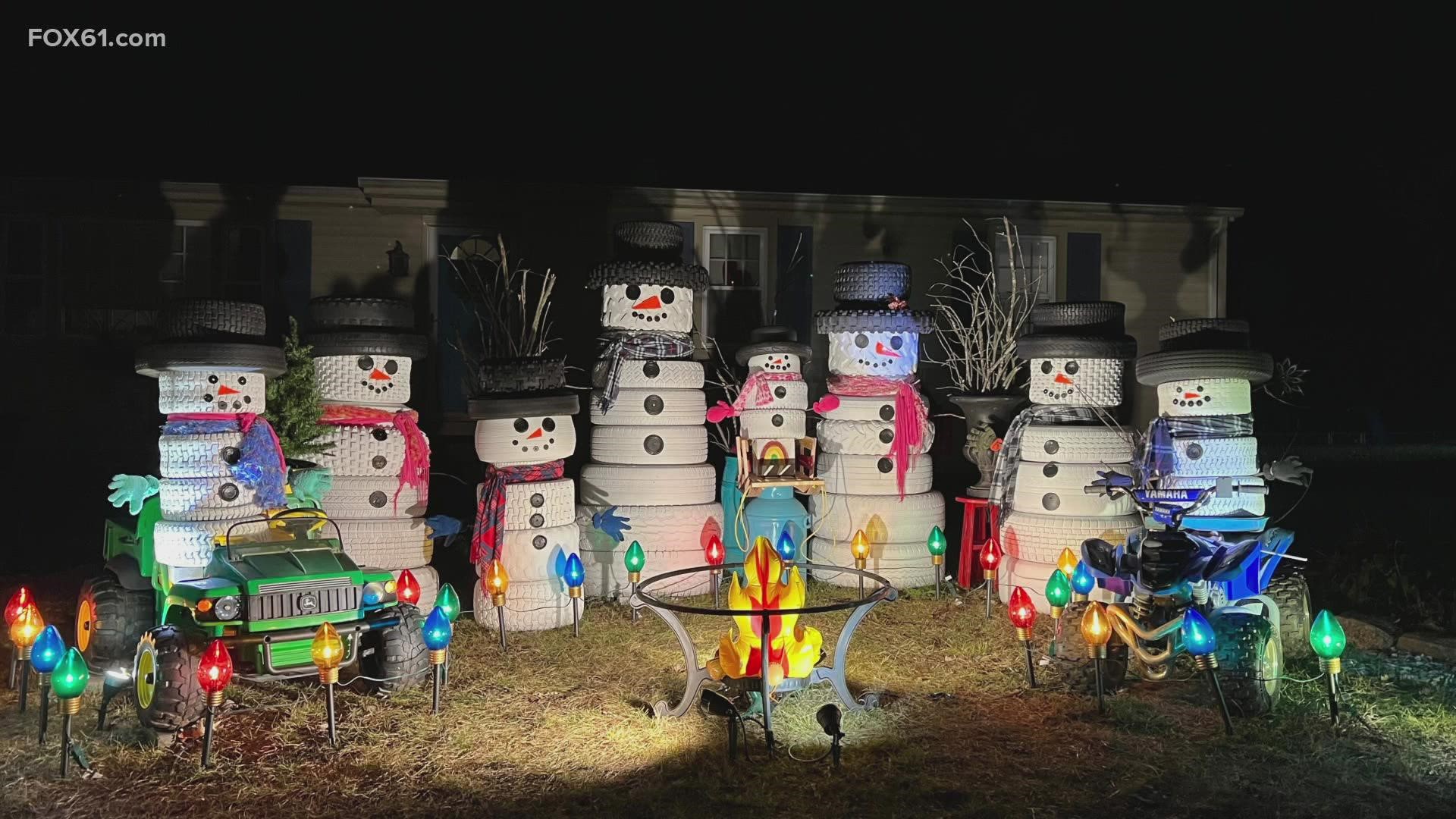 Jennifer Baptiste of Ace of Space created a tire snowman family in her front yard and is collecting donations for a local food pantry and animal control center.