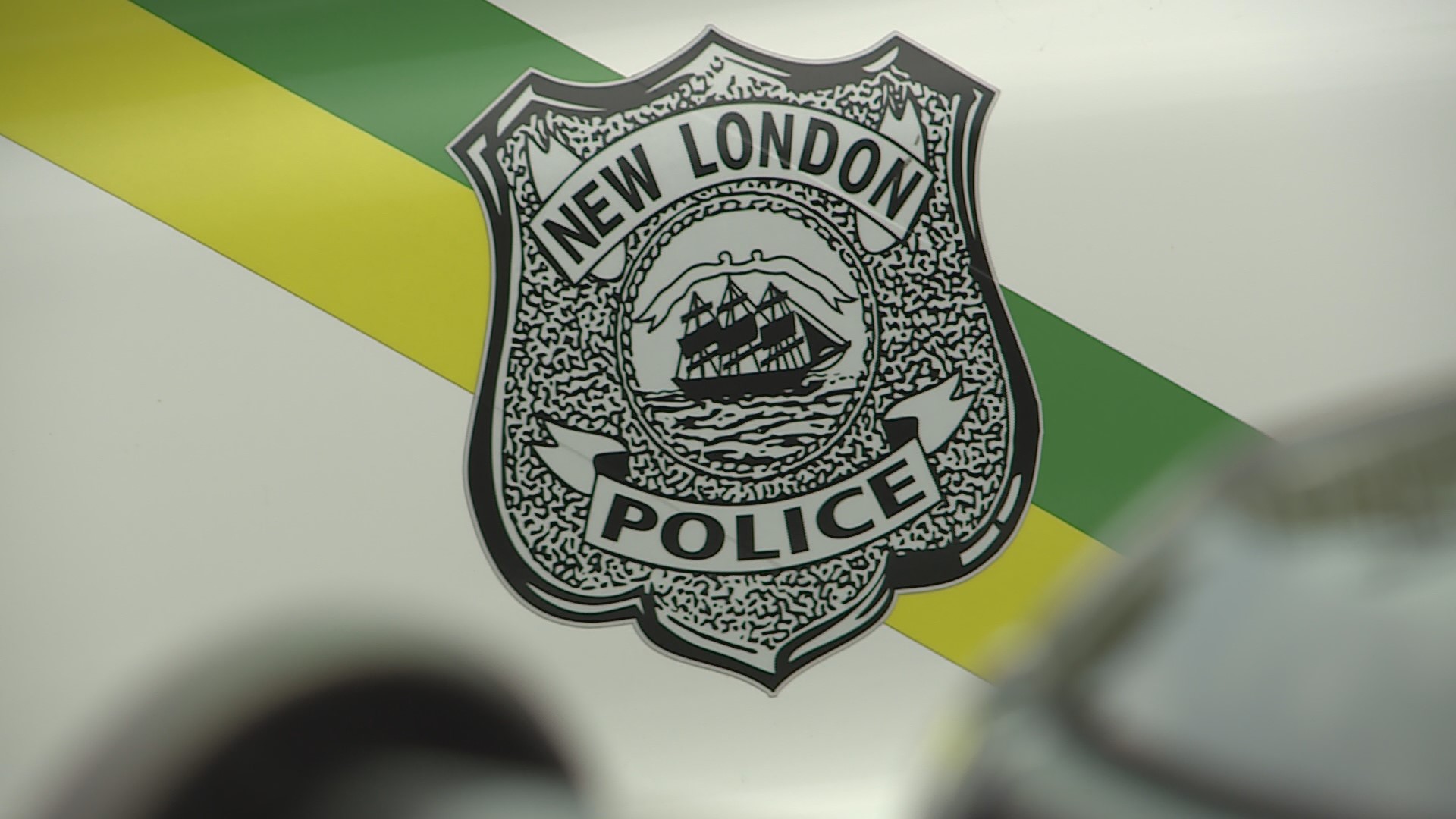 A New London police officer is on paid administrative leave after police arrested him on charges associated with domestic violence. 