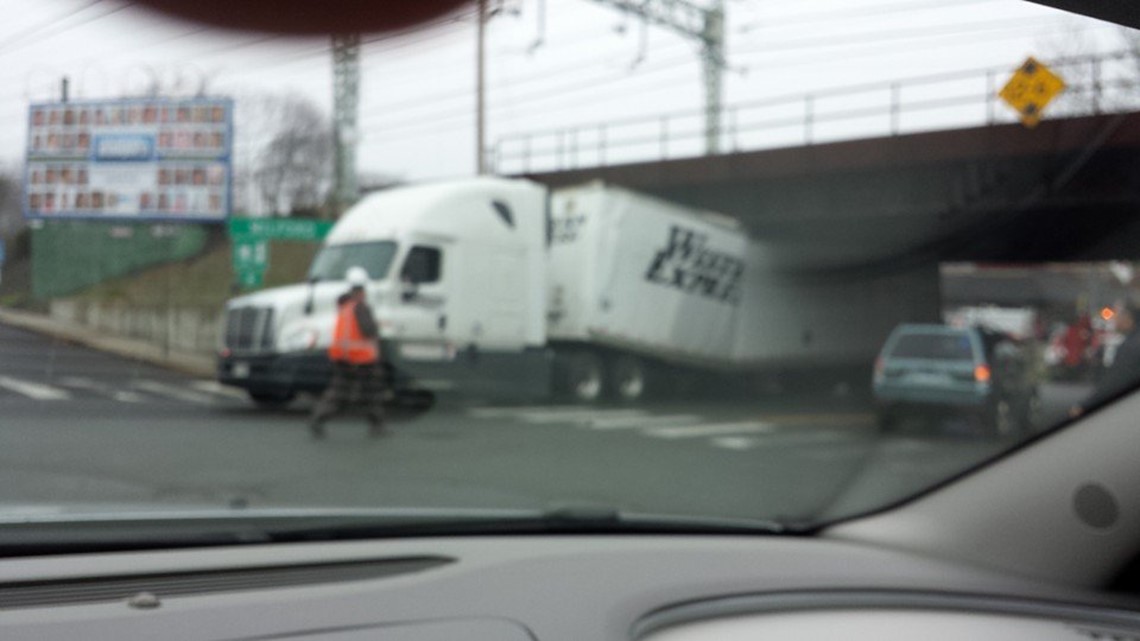 Tractortrailer truck gets stuck under bridge in Milford