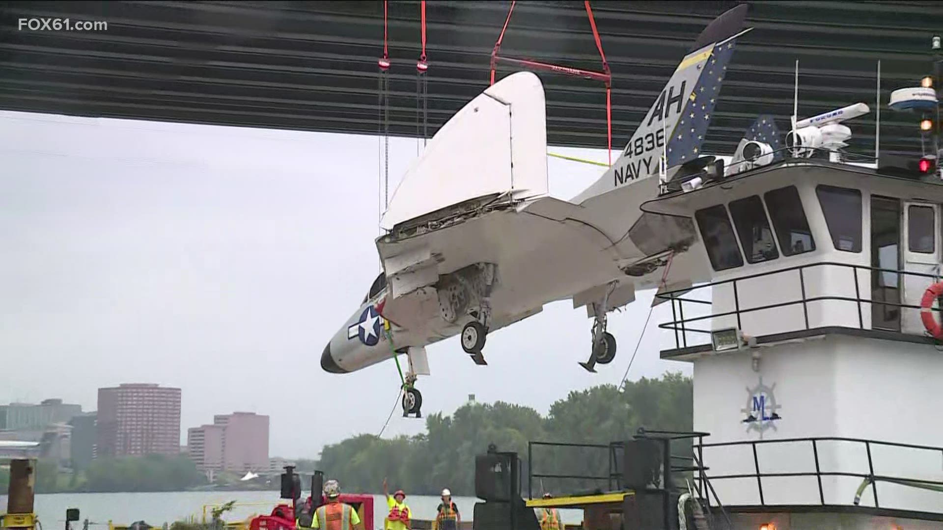 The aircraft was loaded by crane from a flatbed trailer onto a barge, where it will then set off down the Connecticut River