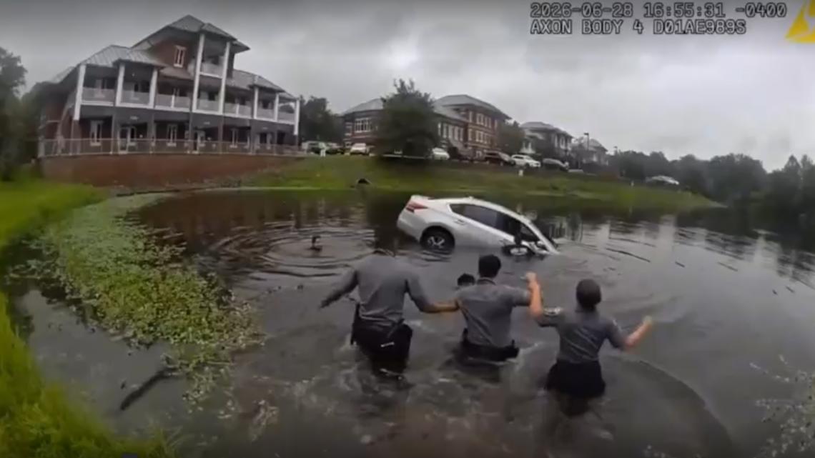 WATCH: Officers form human chain to rescue driver trapped in a sinking car
