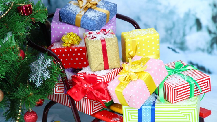 Group at Coastal Edge Surf Shop locations wrap presents for a cause