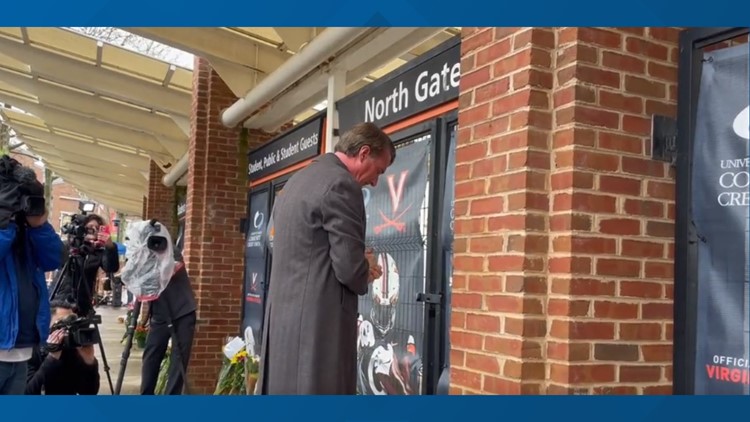 Virginia governor makes impromptu appearance at UVA to leave flowers for three killed students