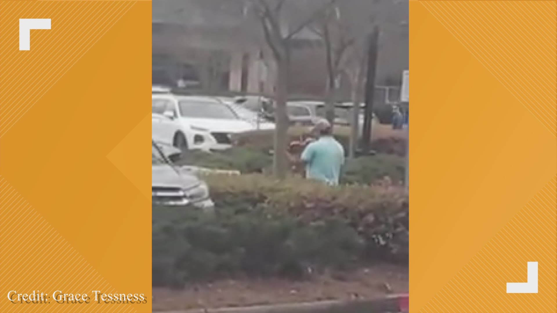 Mystery musician plays his violin as residents rush in and out of Cumming grocery store.