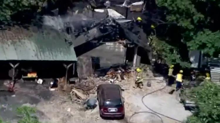 Crews battle woods fire in Gwinnett County that damaged outbuilding