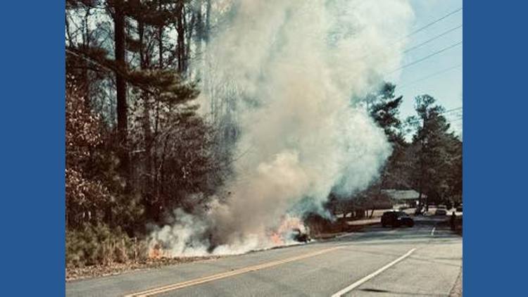 Vehicle crash sparks brush fire in Cherokee County