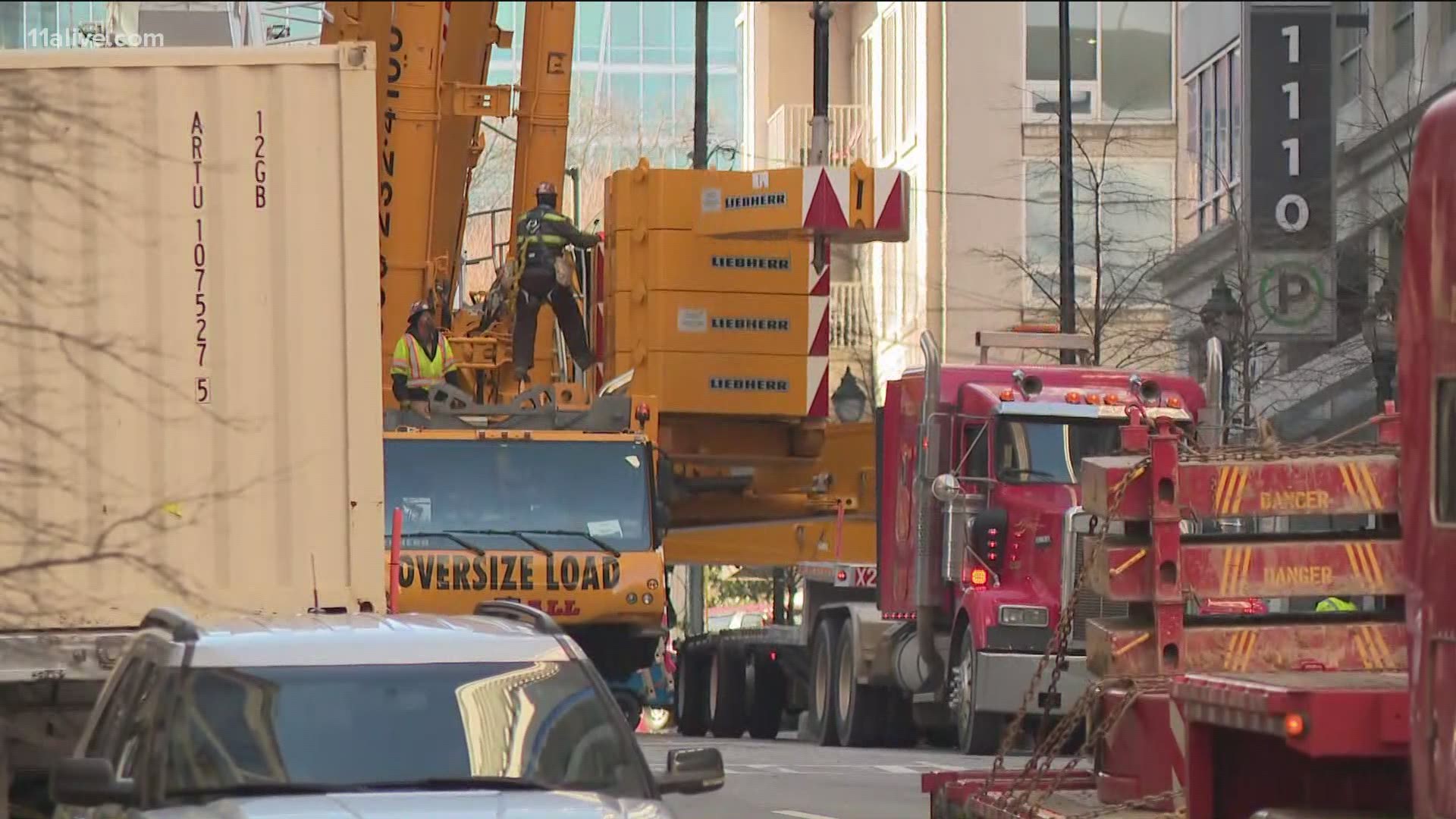 The crane is leaning right into a building located at 13th and West Peachtree Street, which is currently shut down.