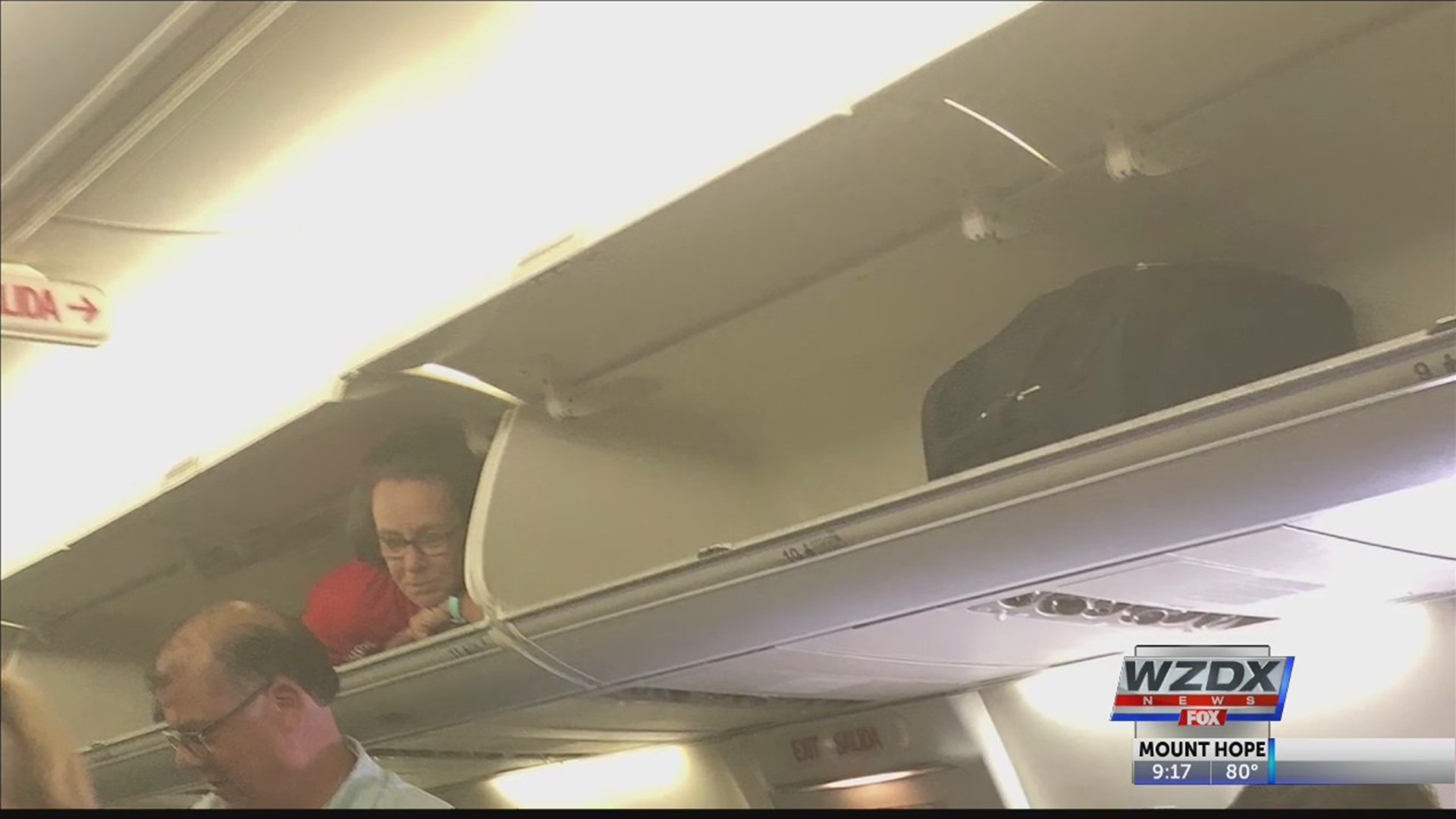 Passengers on a Southwest Airlines flight were surprised when they saw one of their flight attendants greeting them from the comfort of the overhead bin.
