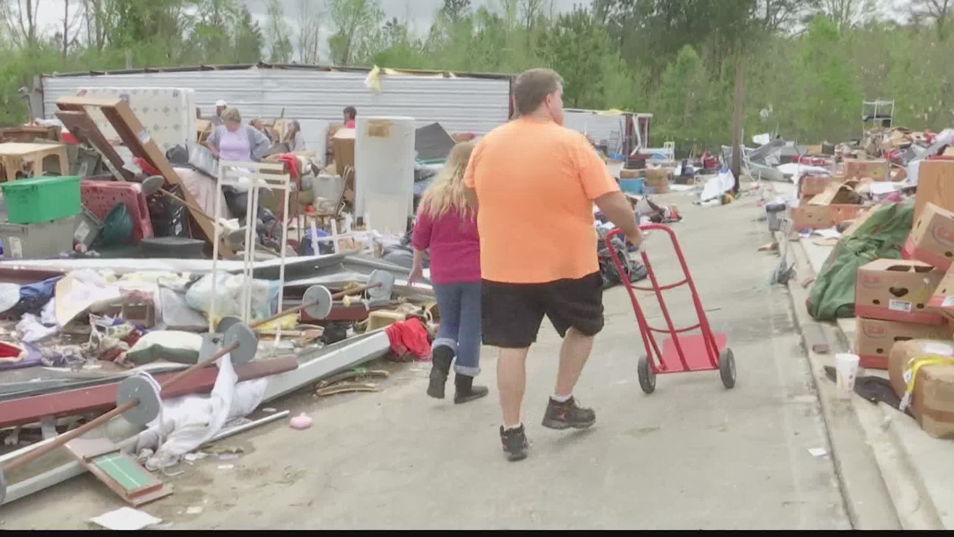 People salvaged items from Highway 431 South Mini Storage after a tornado ripped through the area.
