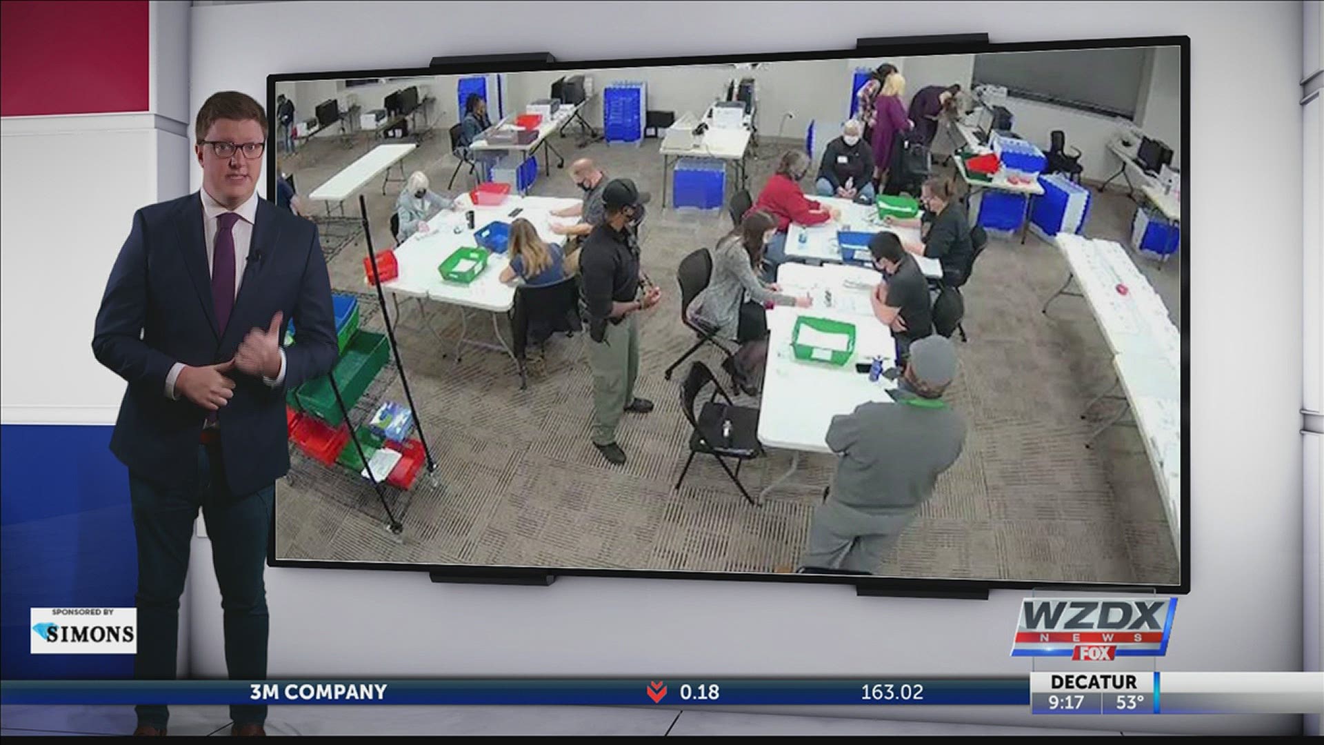 The woman is actually transcribing damaged ballots in front of poll watchers.