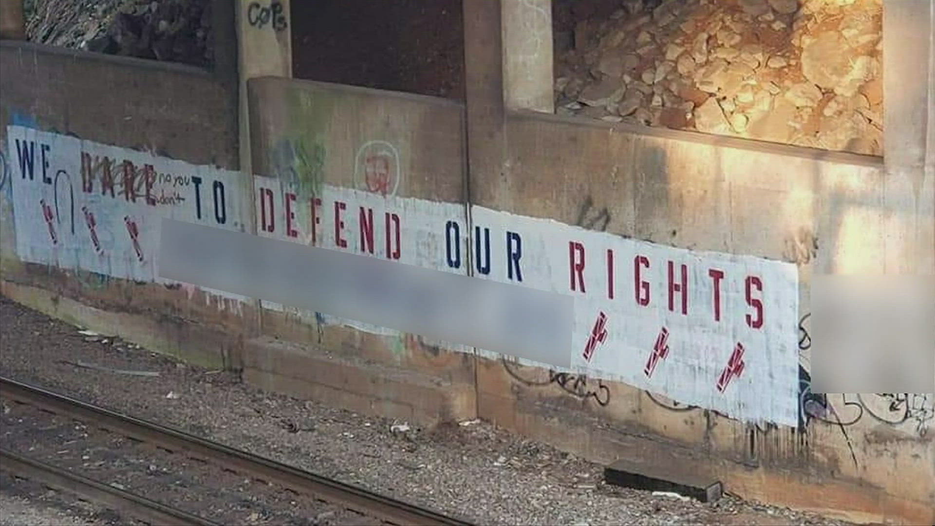 At least one sign is believed connected with a group the Anti-Defamation League calls 'white supremacist extremists.'