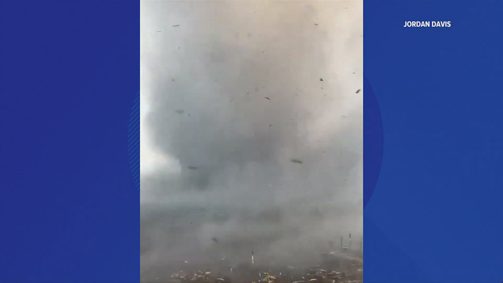 A whirlwind spawned by a passing storm passed over a field on fire Saturday, causing a unique sight.