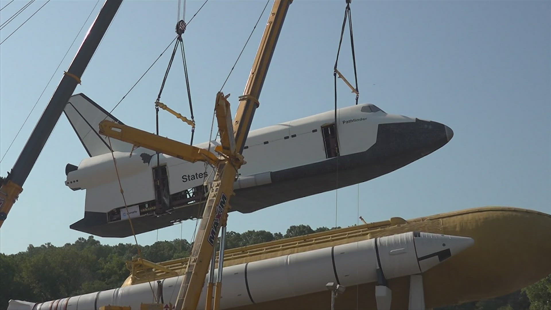 After more than three years of refurbishment, the mock orbiter was hoisted back into place on Wednesday.