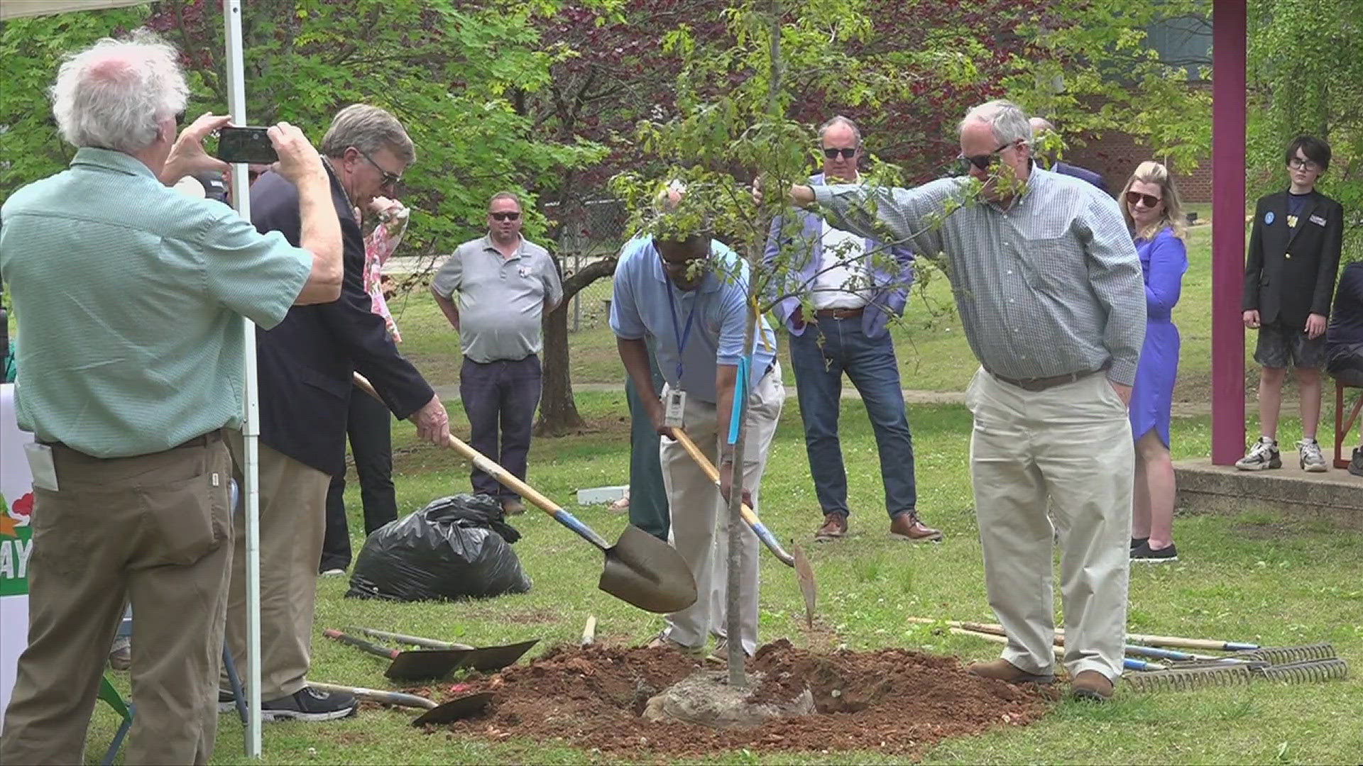 Mayor Tommy Battle planted the tree as part of Arbor Day celebrations.