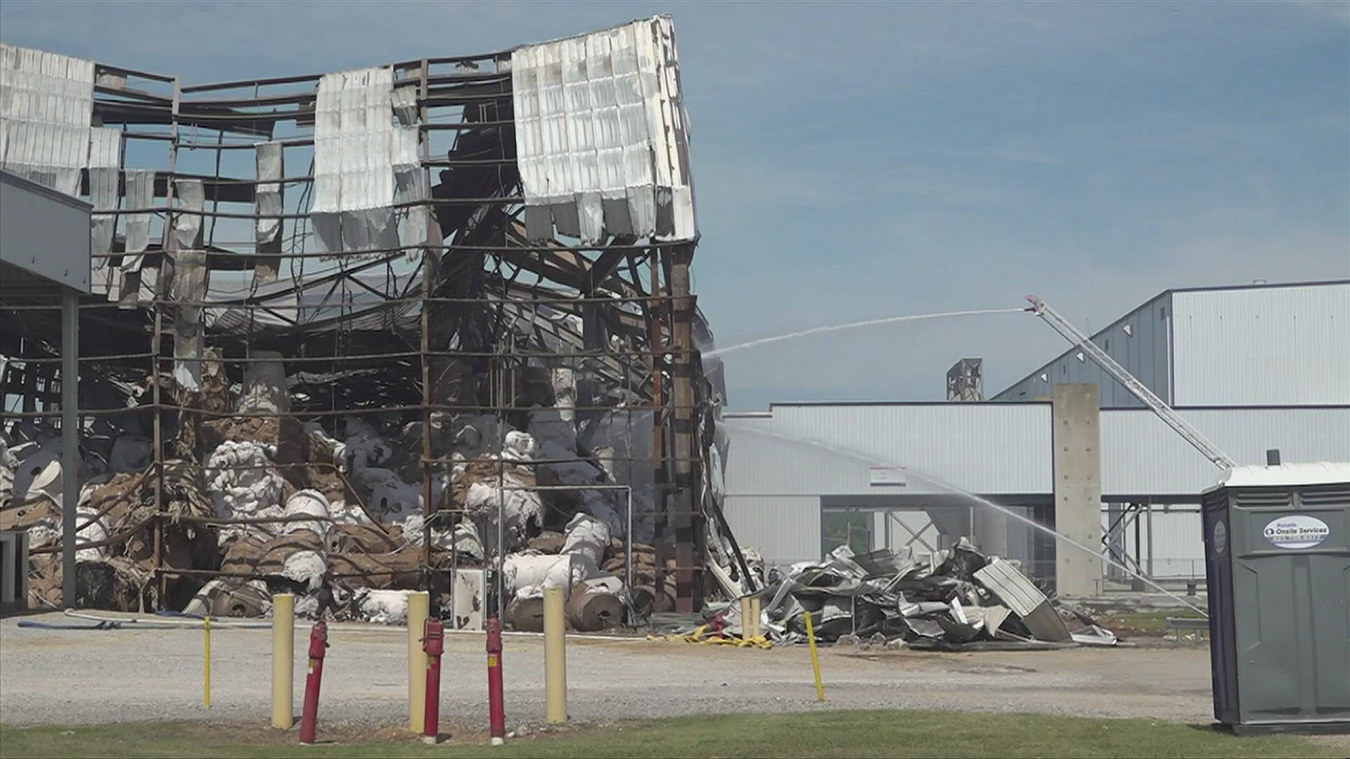 A cause for Saturday's fire remains unknown, as volunteers keep watch over the site and plant officials prepare to reopen to its workforce.