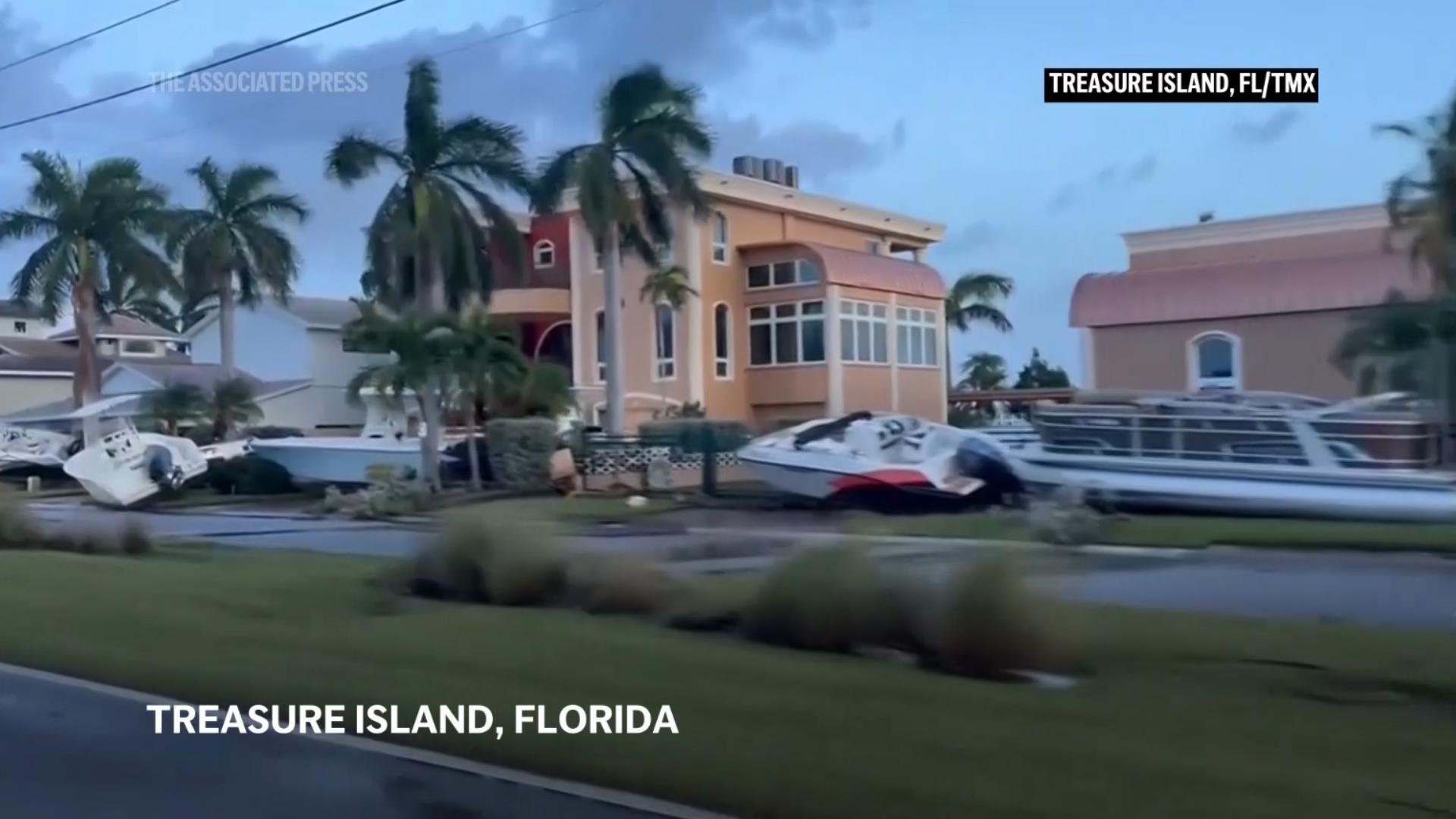 Residents of Treasure Island, Florida woke up to widespread damage and flooding Friday, including boats in yard. after Hurricane Helene slammed onto shore.