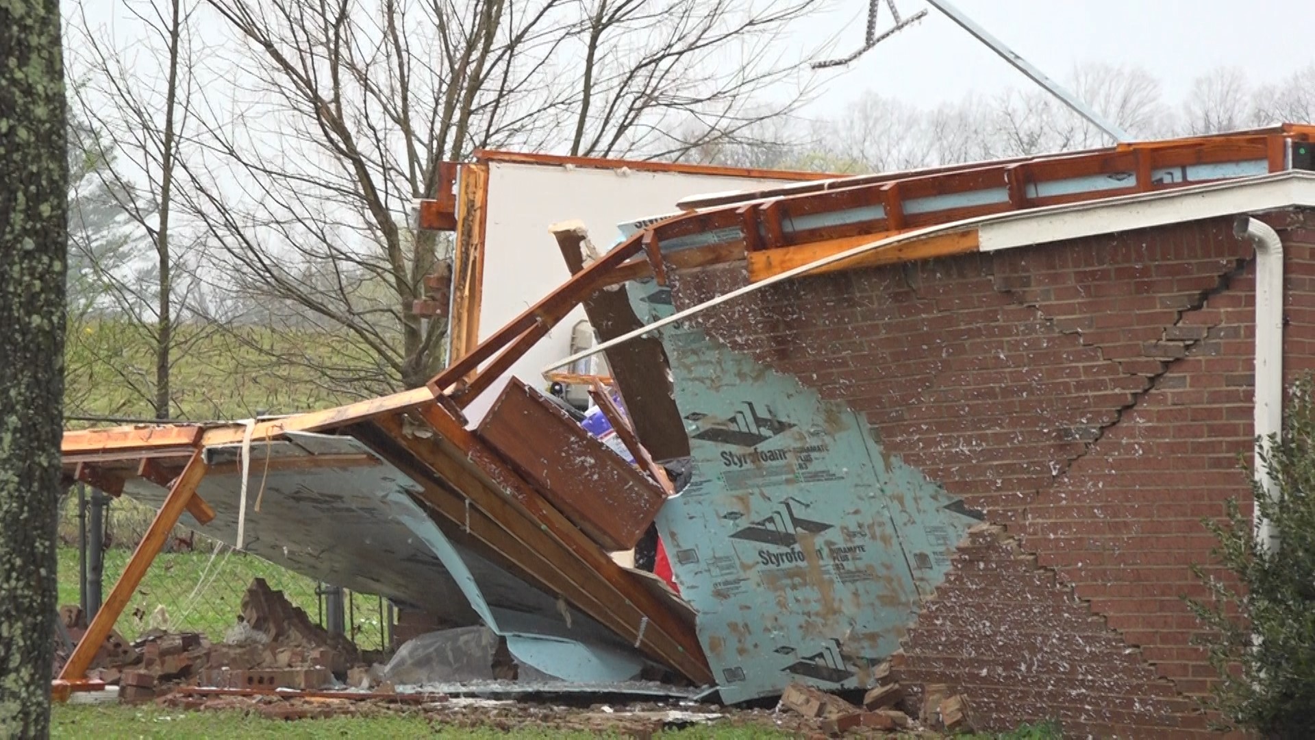 High winds overturned vehicles and tore roofs from homes; more heavy winds expected Friday cause local schools to switch to e-learning.