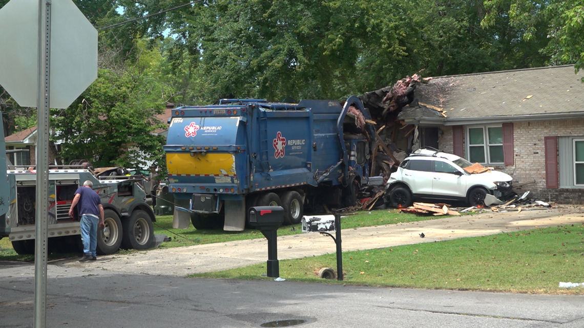 Driver injured after garbage truck plows into Madison home