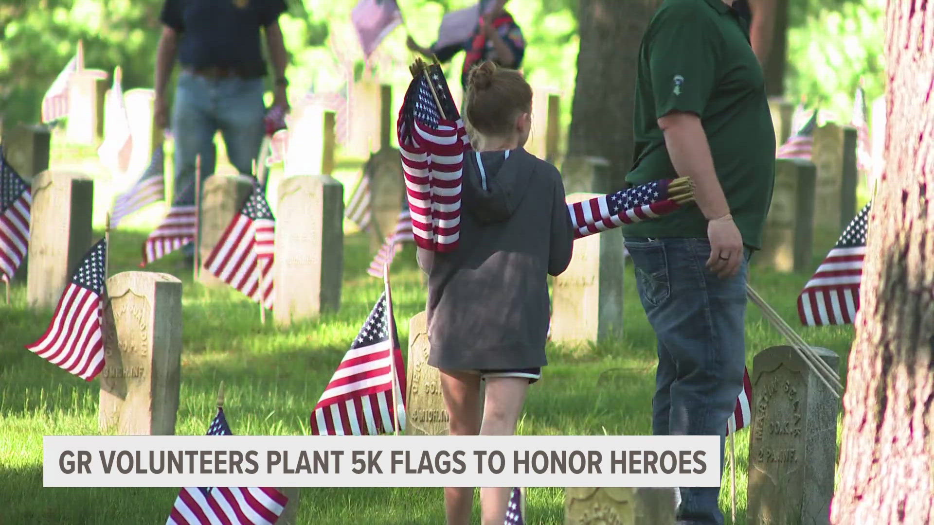 Volunteers gathered at the cemetery outside Michigan Veteran Homes in Grand Rapids to plant more than 5,000 flags ahead of Memorial Day.