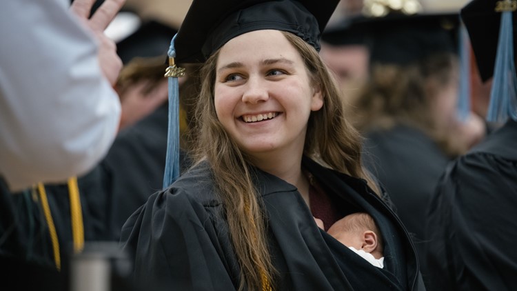 Woman receives diploma with 10-day-old baby tucked in graduation gown Woman receives diploma with 10-day-old baby tucked in graduation gown